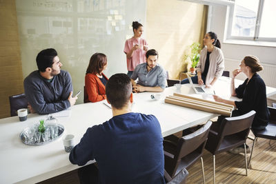 Multi-ethnic business people having discussion on project at conference table