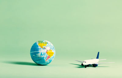 Close-up of airplane flying over blue background