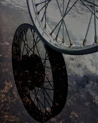 Close-up of bicycle wheel against sky