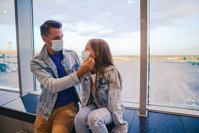 Father and daughter wearing mask at airport