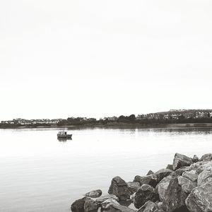 Scenic shot of rock formation and boat in sea