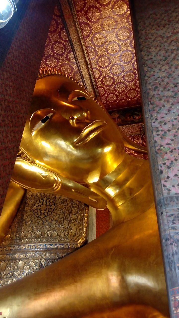 CLOSE-UP OF BUDDHA STATUE IN TEMPLE