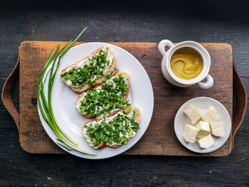 Directly above shot toasted bread by ingredients on cutting board