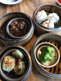 High angle view of dumplings in containers on table