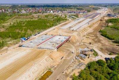 Aerial top view on city construction site. construction of new highway at suburb area