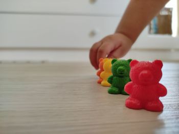 Midsection of person holding toy at home