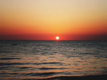 Scenic view of sea against orange sky