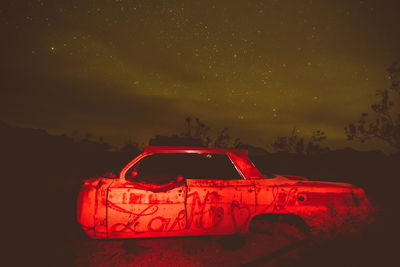 Close-up of illuminated car against sky at night