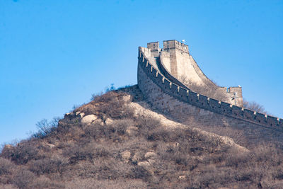 Low angle view of fort against blue sky