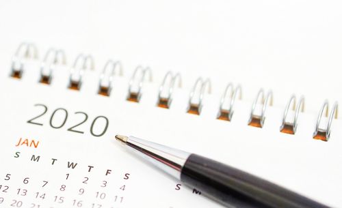 Close-up of pen on paper against white background