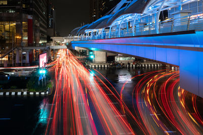 Cityscape of bangkok at night with illumination of skywalk and vehicles