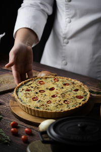 Midsection of man holding pizza