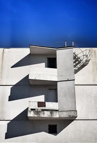 Low angle view of building against clear blue sky