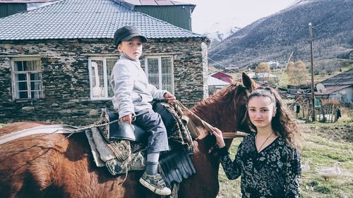 Portrait of smiling young woman with horse