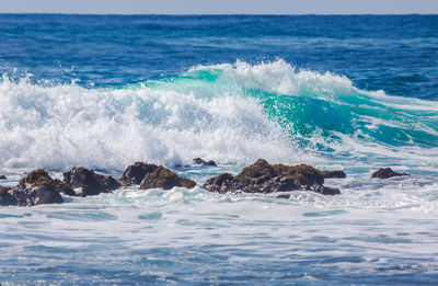 Waves splashing on rocks at shore