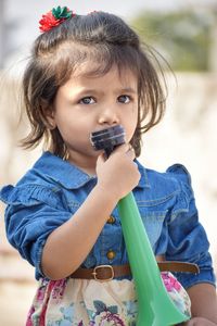 Portrait of cute girl eating food