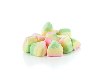 Close-up of multi colored candies against white background