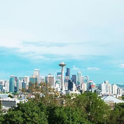 View of cityscape against cloudy sky