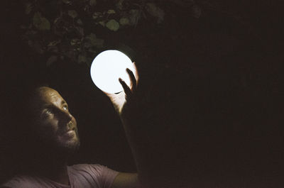 Portrait of young man in illuminated light