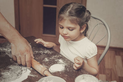 High angle view of mother and daughter in kitchen