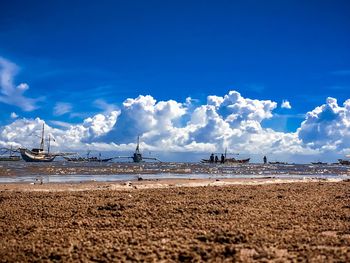 View of beach against cloudy sky