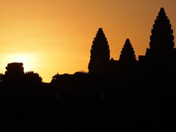 Silhouette temple against sky during sunset