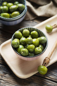 Close-up of green fruits in bowl on table