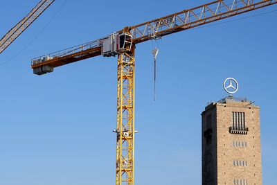 Low angle view of crane against clear sky