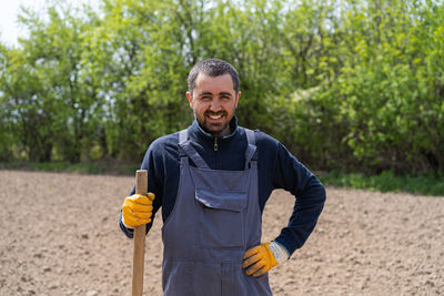 A man planting potatoes in the ground in early spring.
