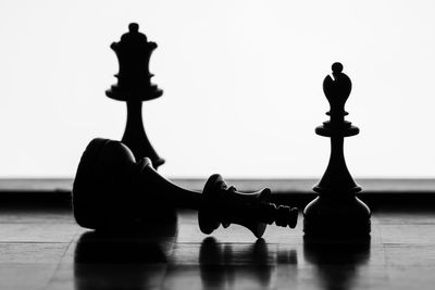 Close-up of chess pieces against white background