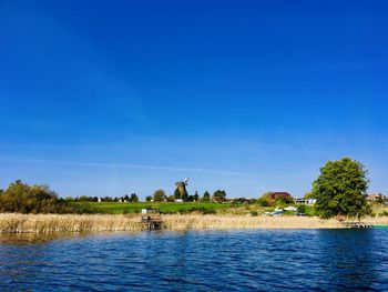 Scenic view of lake against blue sky