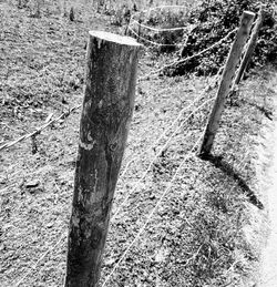 High angle view of wooden post on field