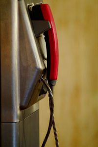 Close-up of telephone booth against wall