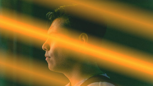 Close-up portrait of young man looking away