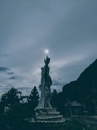 Low angle view of statue against cloudy sky