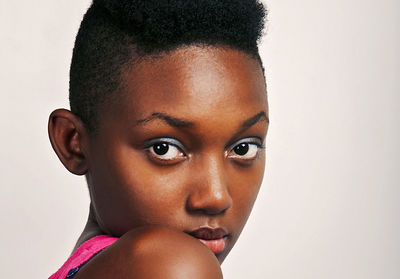 Portrait of beautiful young woman over white background