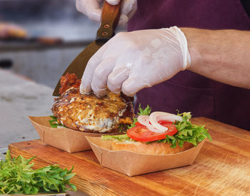 Midsection of person preparing food on cutting board
