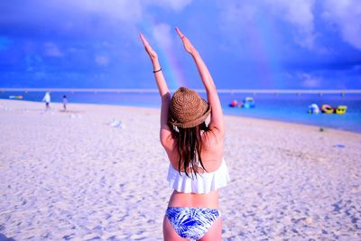 Rear view of woman walking on beach