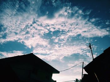 Low angle view of silhouette buildings against sky