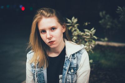 Portrait of young woman standing outdoors