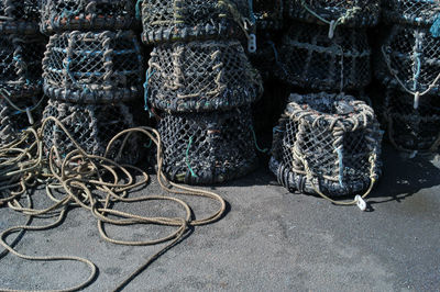 Close-up of rope tied to stacked crab pots on floor
