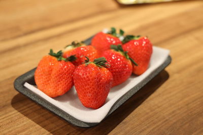 High angle view of strawberries in plate on table