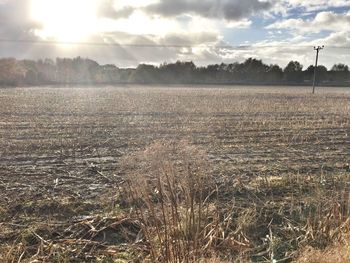 Scenic view of agricultural field against dramatic sky