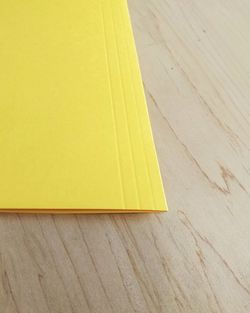 High angle view of yellow table on hardwood floor