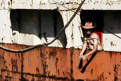 Close-up of clothes hanging on built structure