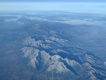 High angle view of snowcapped mountains against sky