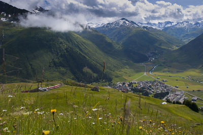 Scenic view of landscape and mountains against sky