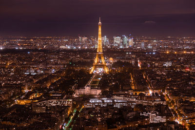 Aerial view of illuminated buildings in city at night