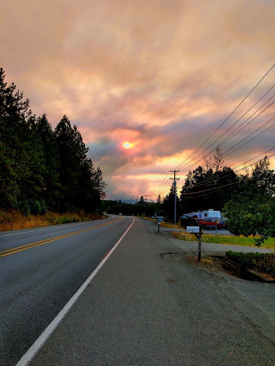 EMPTY ROAD AGAINST SKY DURING SUNSET