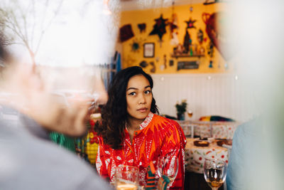 Portrait of a young woman sitting at restaurant